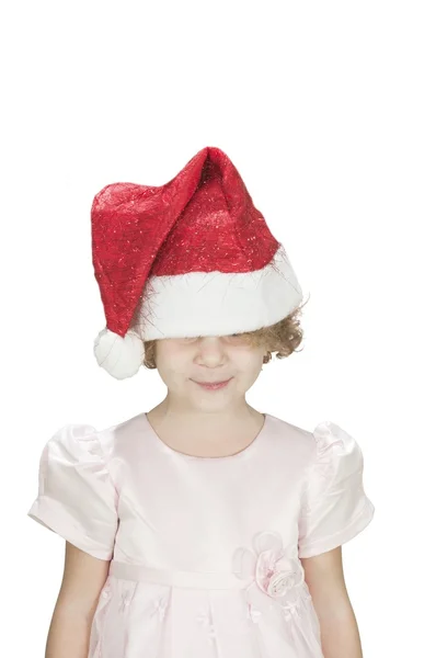 Roztomilý toodler dívka, která nosí santa klobouk na jejích očích, izolované na bílém — Stock fotografie