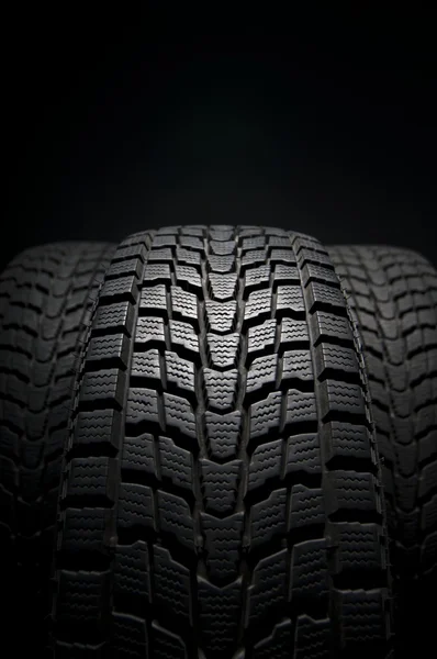 Three black winter tires tread in studio shot — Stock Photo, Image