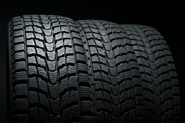 Fechar de três pneus de inverno — Fotografia de Stock