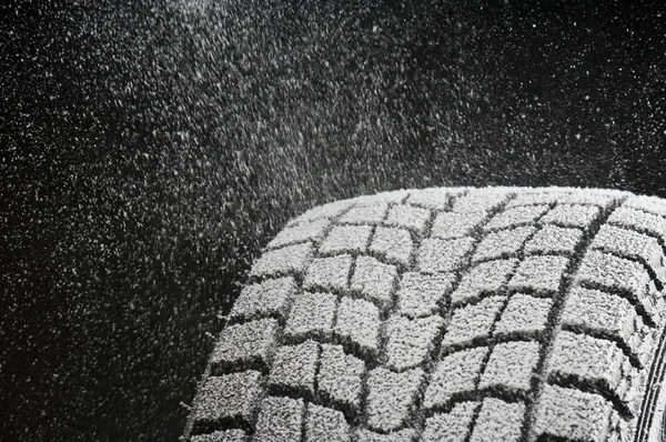 Studio close-up detail of winter tire tread full of snow Stock Picture