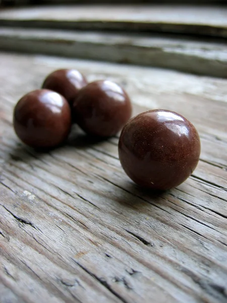 Chocolate balls on an old retro window sill — Stock Photo, Image