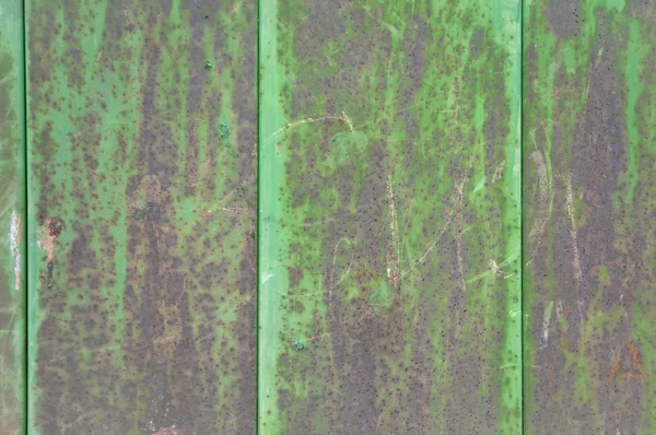 Rusty metal with pieces of old green paint — Stock Photo, Image