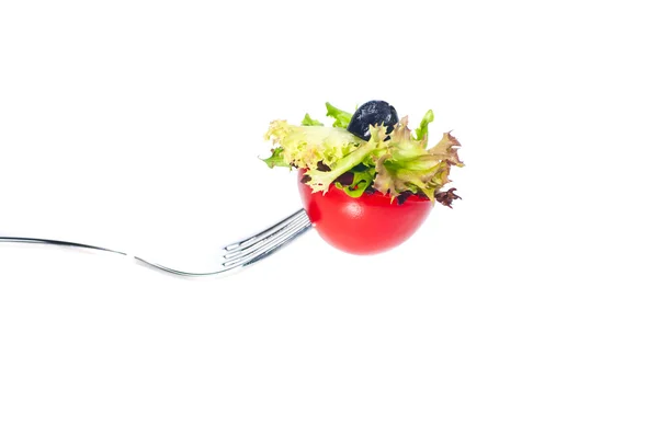 Fresh tomato and salad on a fork — Stock Photo, Image