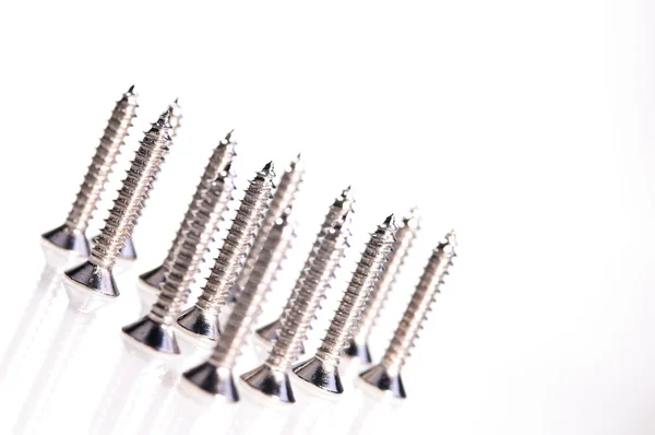 Steel screws middle focus over white — Stock Photo, Image