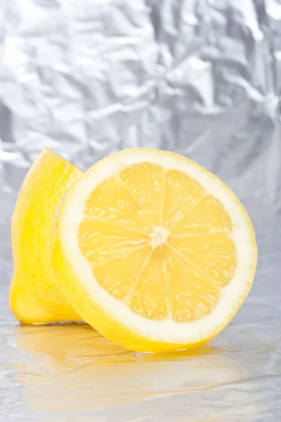Half lemon on silver background