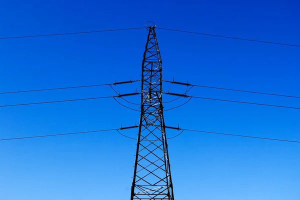 Wysoki elektryczne Pylonu na niebieski niebo jako tło — Zdjęcie stockowe