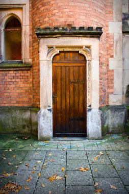 Wooden church door with stone and brick wall surround clipart