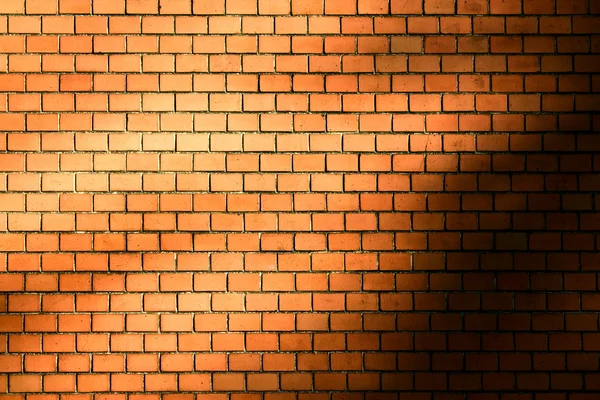 Orange brick wall background with natural shadow vignette — Stock Photo, Image