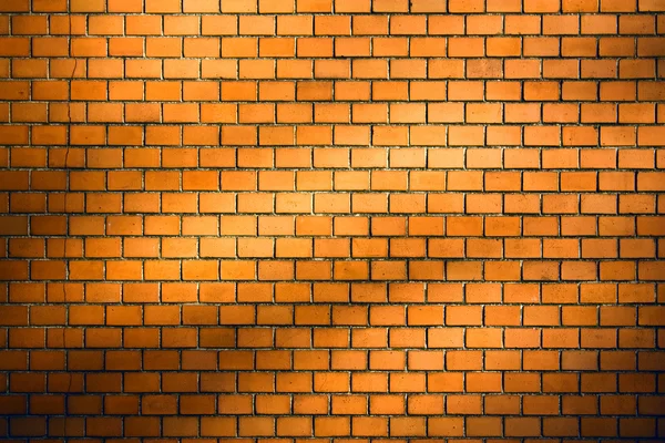 Orange brick wall background with natural shadow vignette — Stock Photo, Image