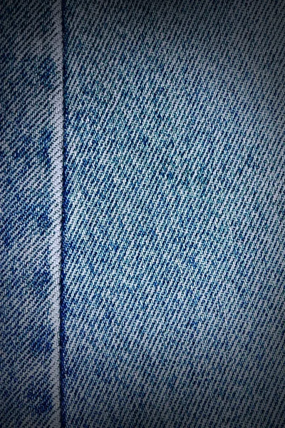 Worn blue denim jeans texture, vignette background to insert text or design — Stock Photo, Image