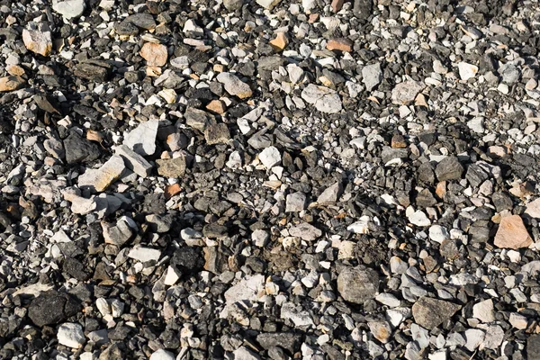 Skutečné textura malých šedých kamenů jako červené pozadí návrhu — Stock fotografie