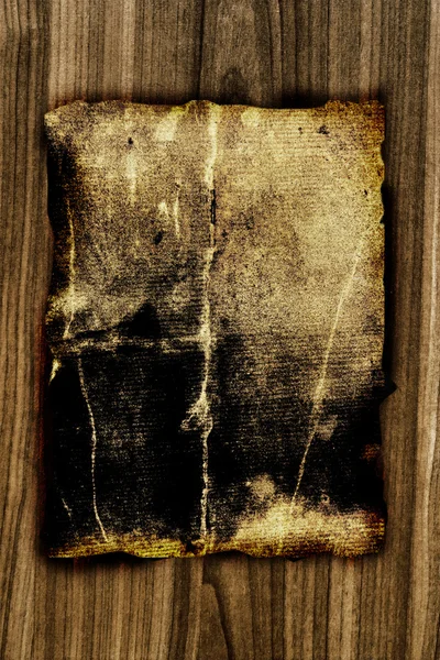 Papel viejo oscuro sobre tabla de madera — Foto de Stock