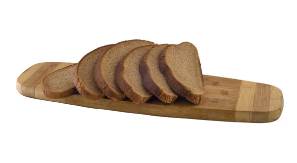 De stukken van rogge bruin brood op de snijplank. — Stockfoto