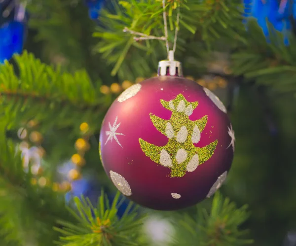 The Christmas-tree decoration in the form of purpur ball. — Stock Photo, Image