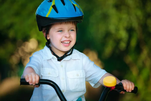 Portrait of a cute little boy in a bicycle — Stock Photo, Image