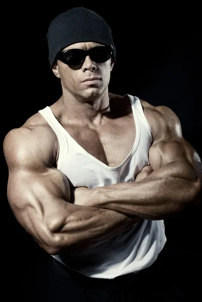 Strong athletic man in dark glasses — Stock Photo, Image