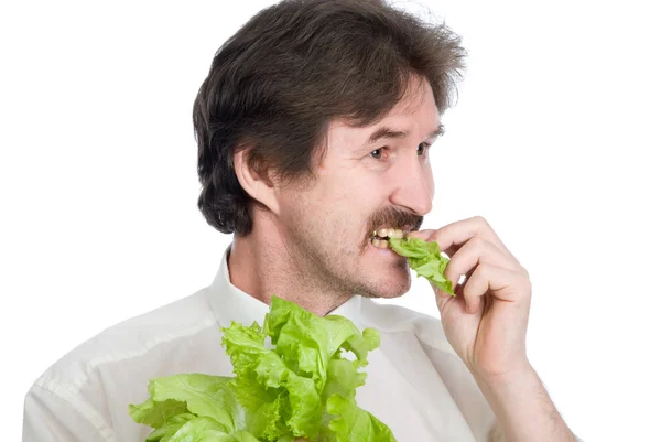 Homme mange feuille de la salade — Photo