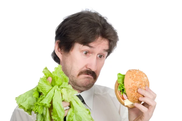 Вибір бізнесмена-салату або гамбургера — стокове фото