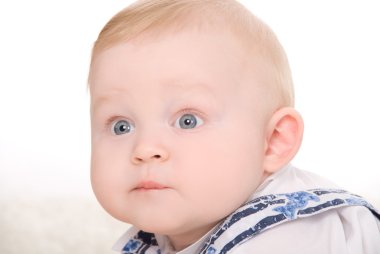 Bright closeup picture of blue-eyed baby boy clipart