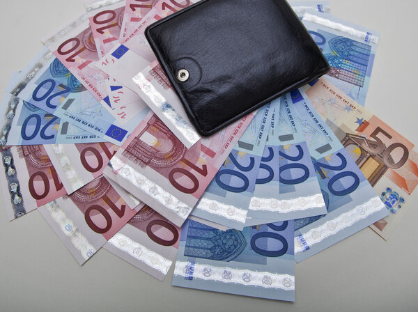 Black leather wallet with euro banknotes fanning out