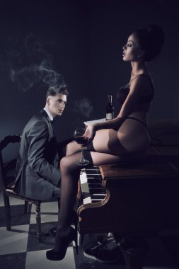 Sexy couple with piano clipart