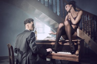 Sexy couple in an intimate situation with piano clipart