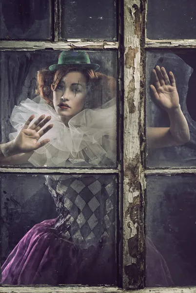A lonely pierrot woman behind the glass — Stock Photo, Image