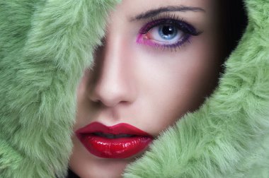 Portrait of young beautiful woman with green fur. clipart