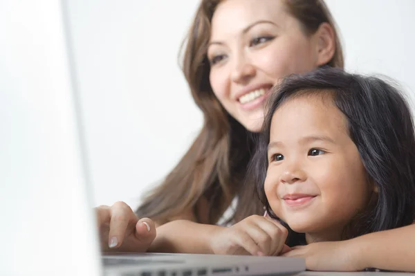Little Girl smiling with Mother Stock Image