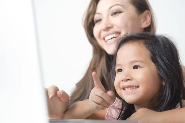 Little Girl Pointing at laptop happy Stock Picture