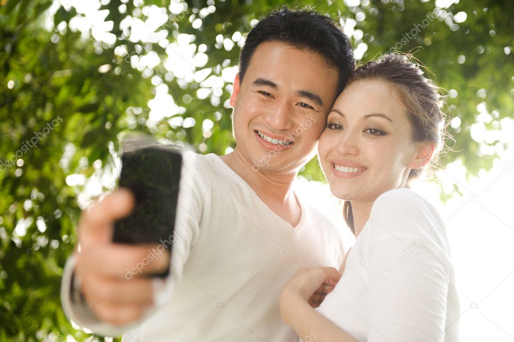 Asian Couple Taking Photographs - Stock Photo, Image. 