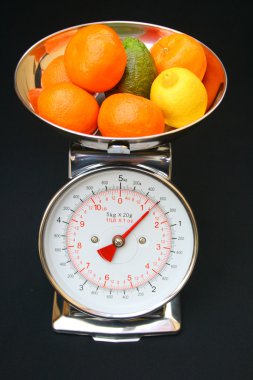 Kitchen scales with fruit. clipart