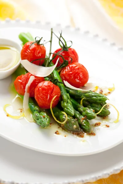Groene asperges met geroosterde tomaten — Stockfoto