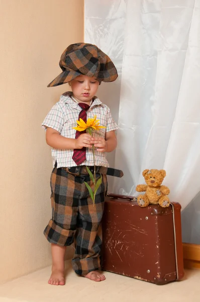 Милый маленький мальчик с цветочком. На нем шляпа. . — стоковое фото