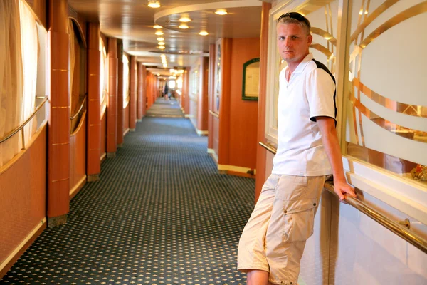 Young man in a corridor inside the ferry — Stock Photo, Image