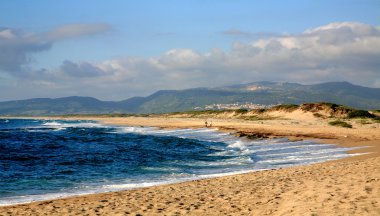 Walking at the beach Valledoria Sardinia Italy clipart