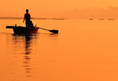 Two boys in a boat on the Ganges clipart