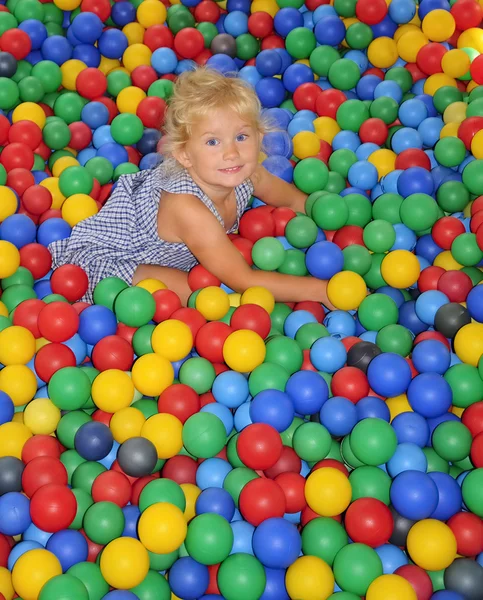 Happy girl playing in balls. — Stock Photo, Image