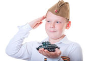 Der Junge hält ein Knetmasse-Modell des Panzers in der Hand