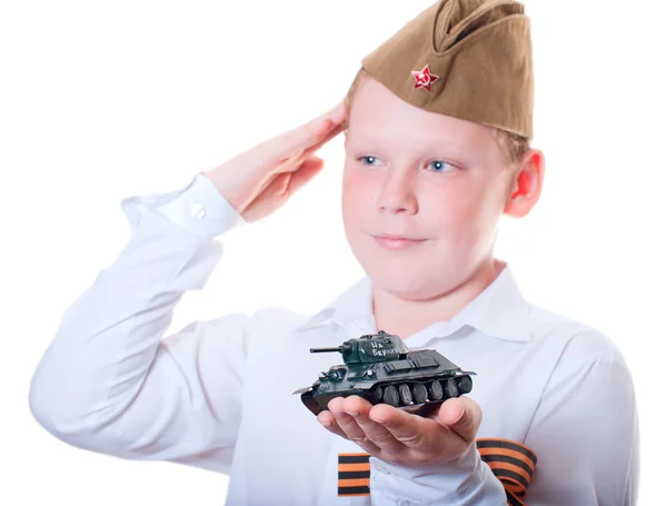 The boy is holding a plasticine model of the tank — Stock Photo, Image