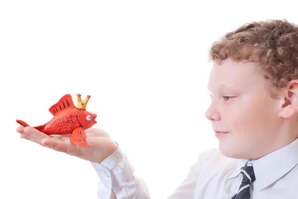 Boy holding a goldfish out of plasticine — Stock Photo, Image