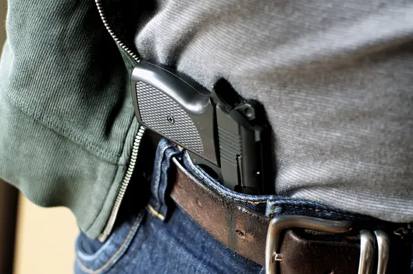 Pistol hidden in belt — Stock Photo, Image