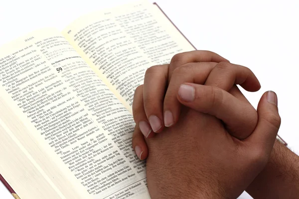 La Bibbia aperta con una mano Fotografia Stock
