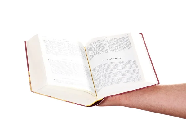 Bidden hand houdt een open Bijbel — Stockfoto