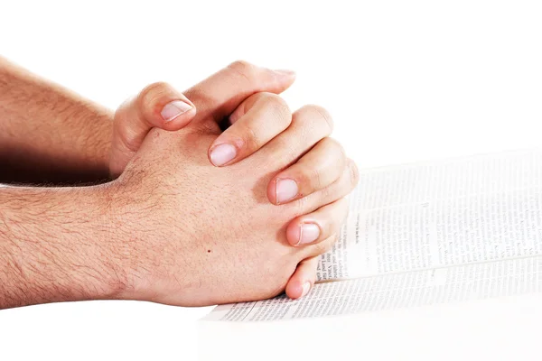 Betende Hand hält eine offene Bibel — Stockfoto