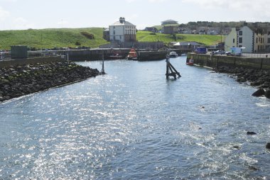 Sunlight glistening on water in Eyemouth harbour, Berwickshire clipart