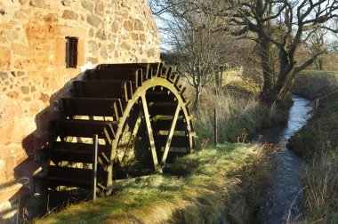 Old mill wheel and stream at Preston Mill, East Linton clipart