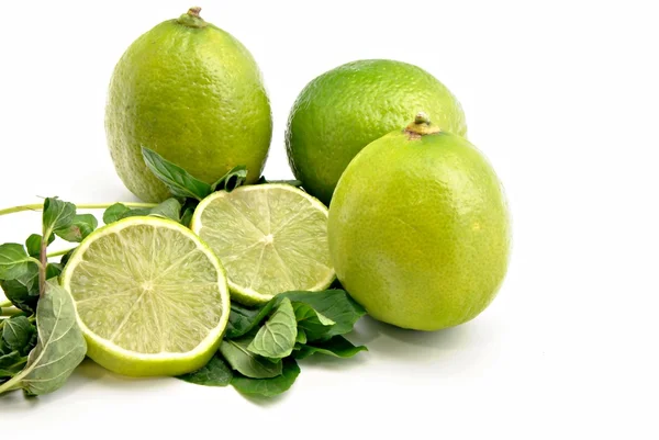 Several limes with lime slices — Stock Photo, Image