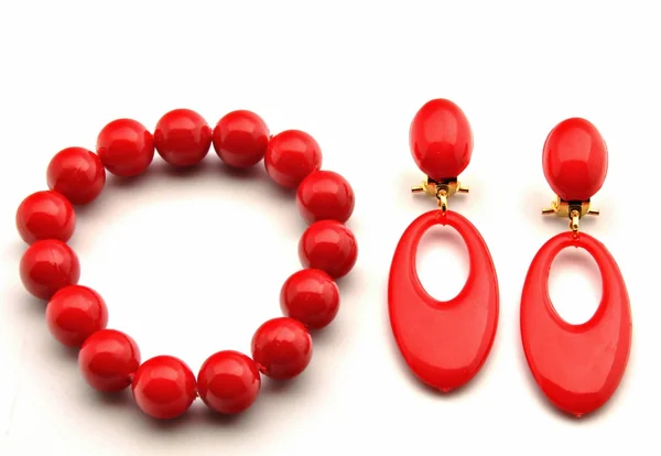 Two earrings red by red bracelet — Stock Photo, Image
