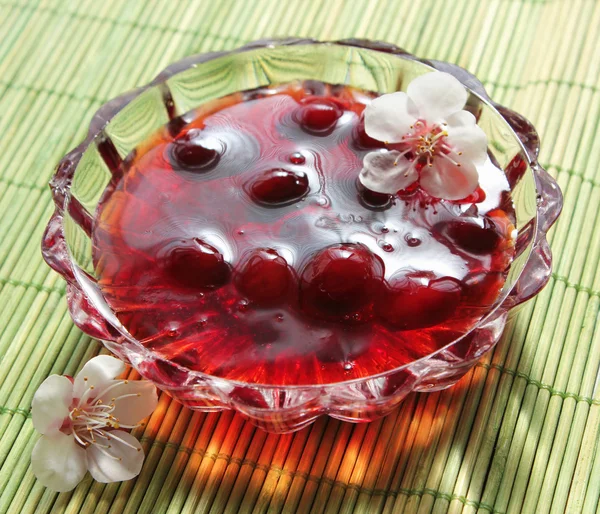 Stock image Cherry preserves in a saucer and flower